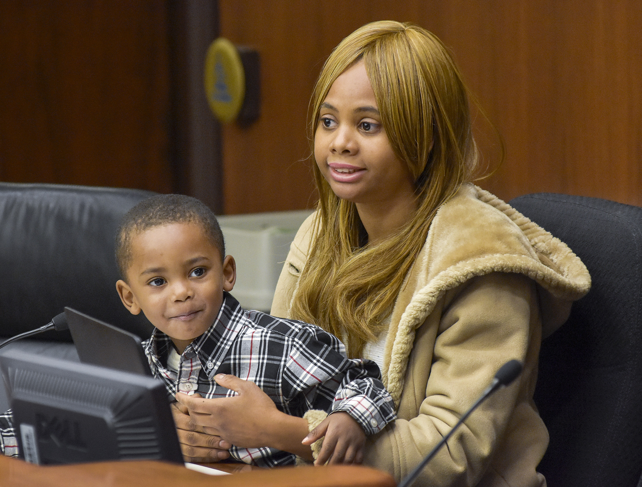 Tish Penny and her 3-year-old son, Ethan, testify before the House Agriculture Finance Committee April 5 in support of a bill that would establish an urban agriculture development pilot program. Photo by Andrew VonBank